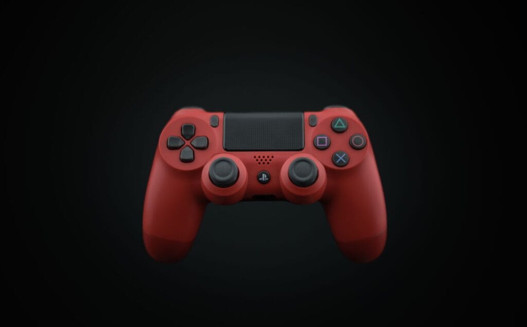 Czerwony kontroler DualShock PS4 na ciemnym tle